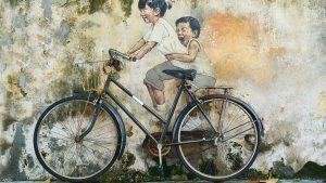 Boys on a bike enjoying themselves