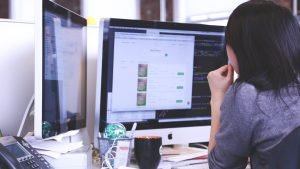 Woman at a computer with lots of windows open