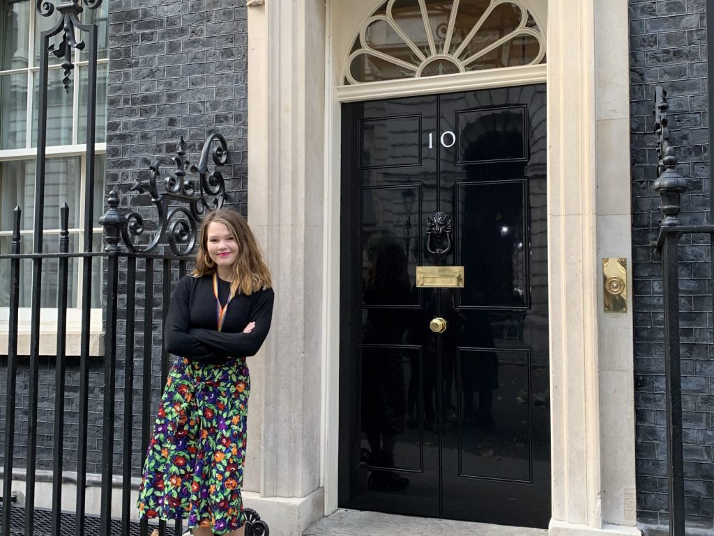 Portrait image of Abigail Emery standing outside 10 Downing street